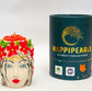 Decorative candle shaped like a face with flowers and a cylindrical container labeled 'Happipears' on a white background.